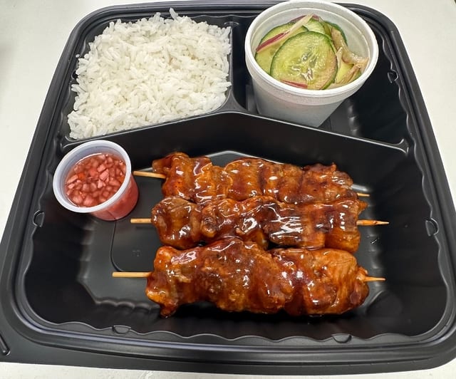 Combo 1: Pork BBQ Stick with Steamed Rice and Cucumber Salad.